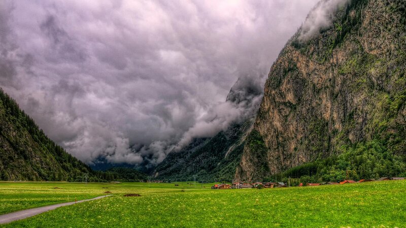 Village in Mountain Valley — Green, Dramatic, Afternoon, Photograph, Mountains, Clouds, Fields