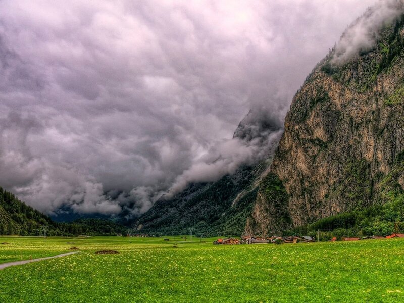 Village in Mountain Valley — Green, Dramatic, Afternoon, Photograph, Mountains, Clouds