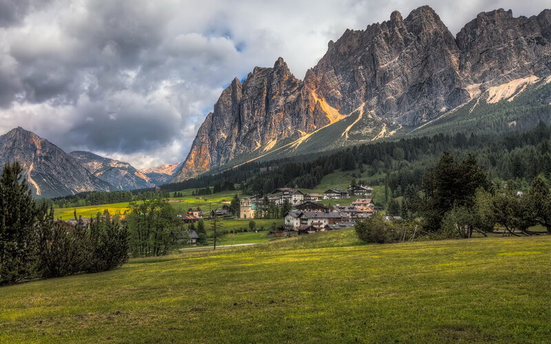 Village in Mountain Valley — Green, Dramatic, Afternoon, Photograph, Mountains, Forest