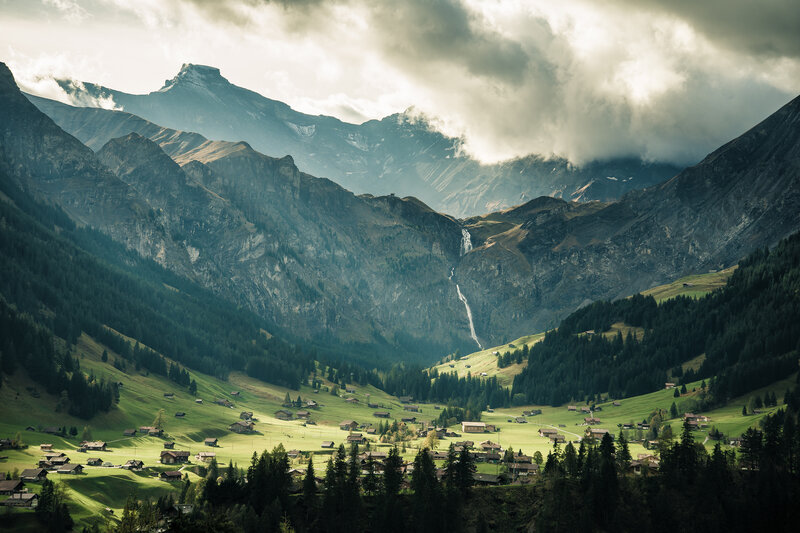 Village in Mountain Valley — Green, Dramatic, Afternoon, Photograph, Mountains, Forest, Waterfall