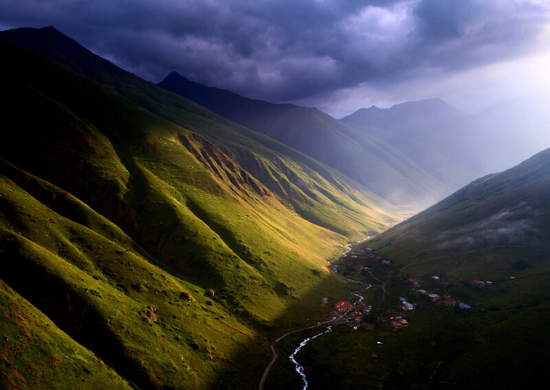 Village in Mountain Valley — Green, Dramatic, Afternoon, Photograph, Mountains, River