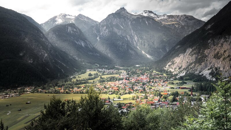 Village in Mountain Valley — Green, Dramatic, Afternoon, Photograph, Mountains, Trees