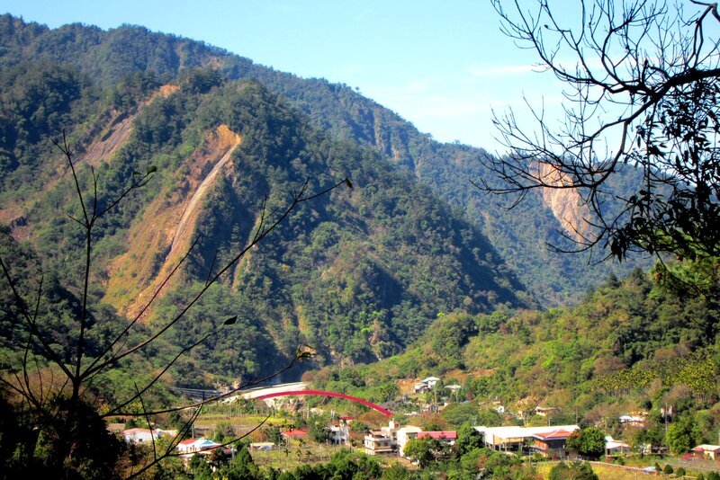 Village in Mountain Valley — Green, Serene, Afternoon, Photograph, Bridge
