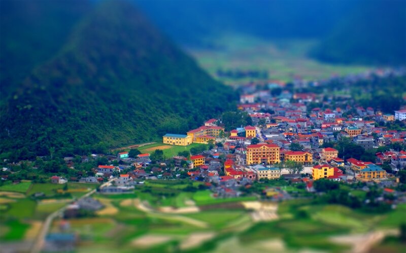 Village in Mountain Valley — Green, Serene, Afternoon, Photograph, Buildings, Fields