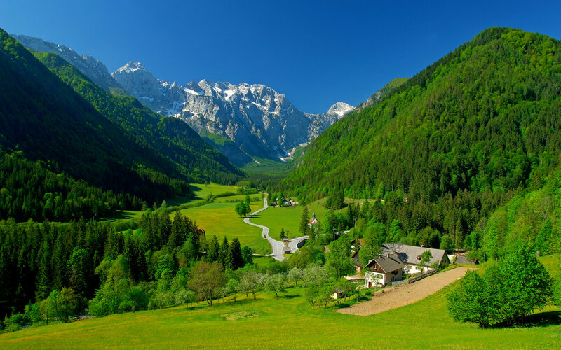 Village in Mountain Valley — Green, Serene, Afternoon, Photograph, Mountains, Forests, Road