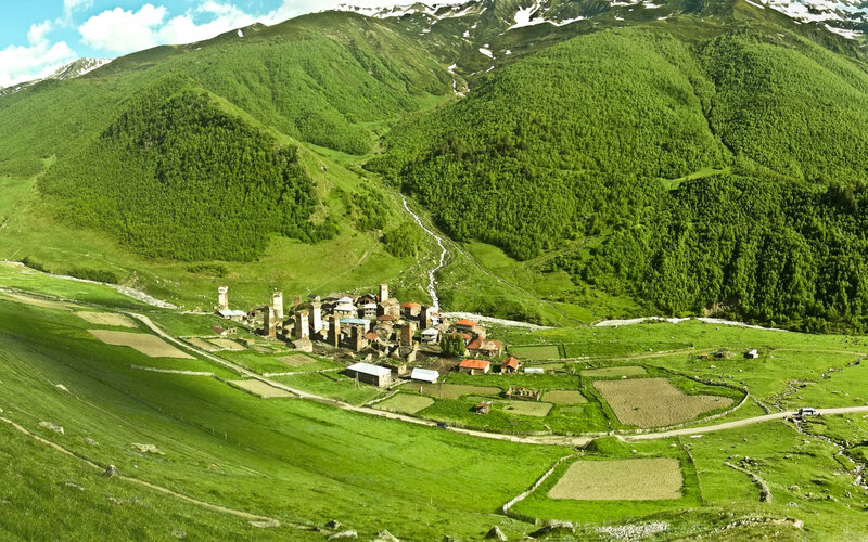 Village in Mountain Valley — Green, Serene, Afternoon, Photograph, Mountains, River, Fields