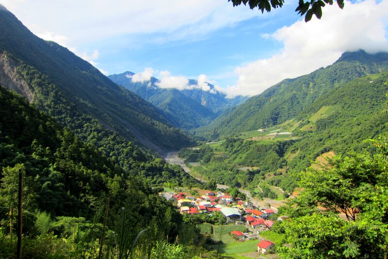 Village in Mountain Valley — Green, Serene, Afternoon, Photograph, Mountains, River, Houses