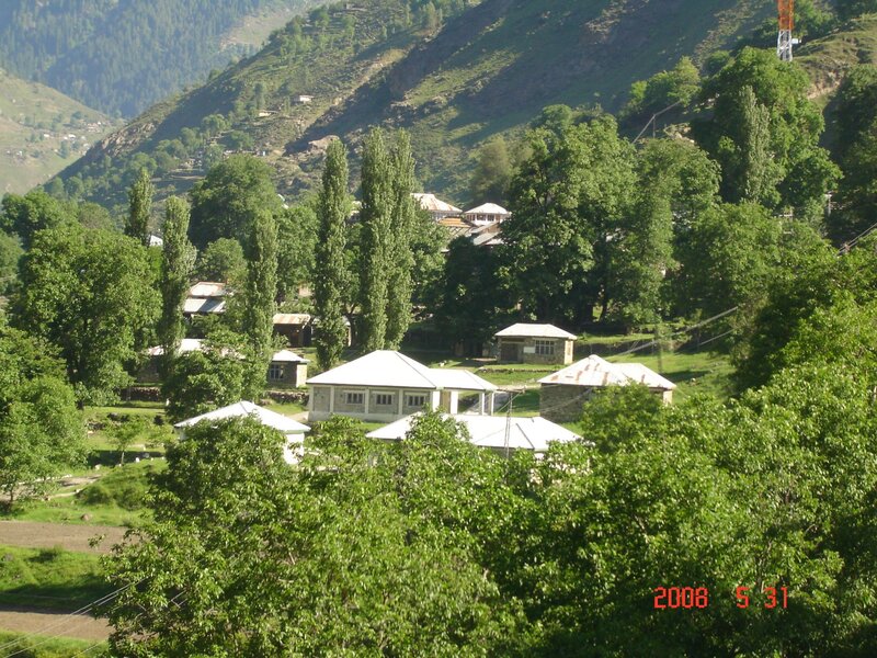 Village in Mountain Valley — Green, Serene, Afternoon, Photograph, Mountains, Trees, Buildings, Power Lines