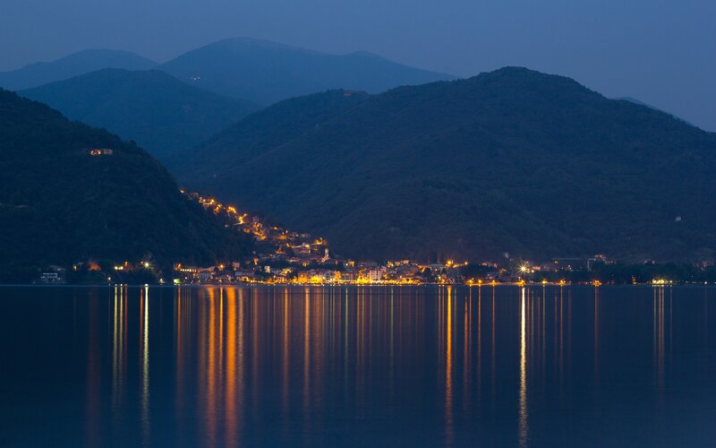 village lights on lake at dusk