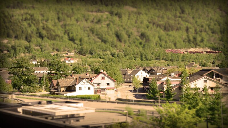 village nestled in a forested valley