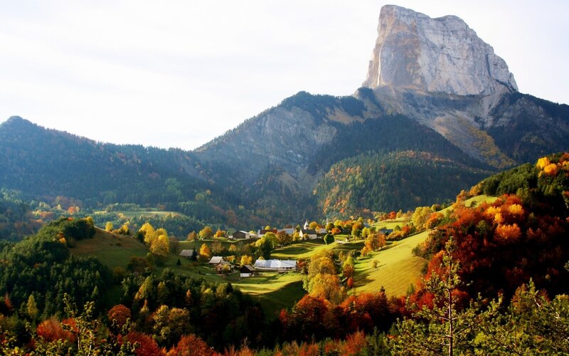 Village nestled in autumn mountains