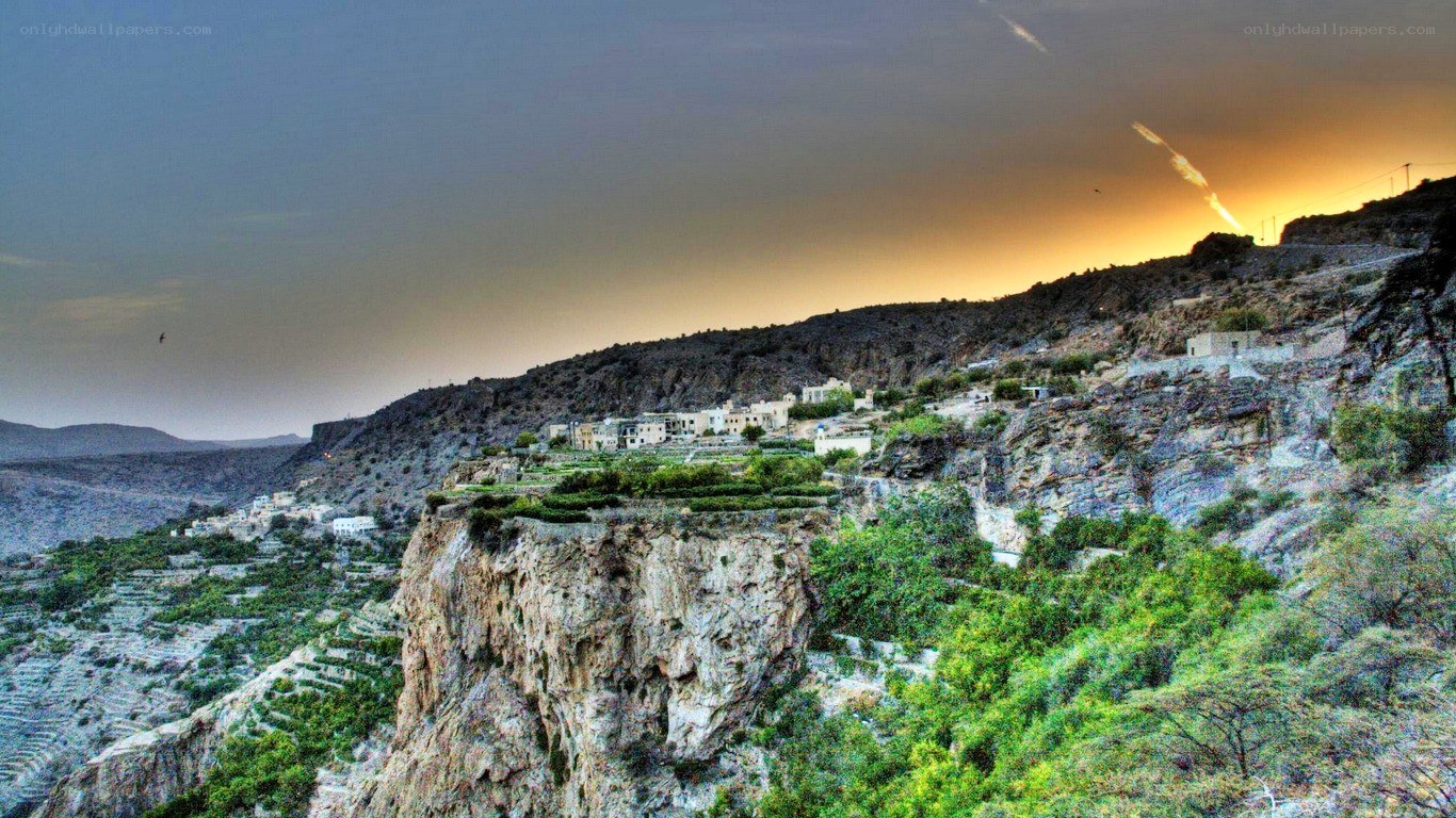 village on a cliff at sunset