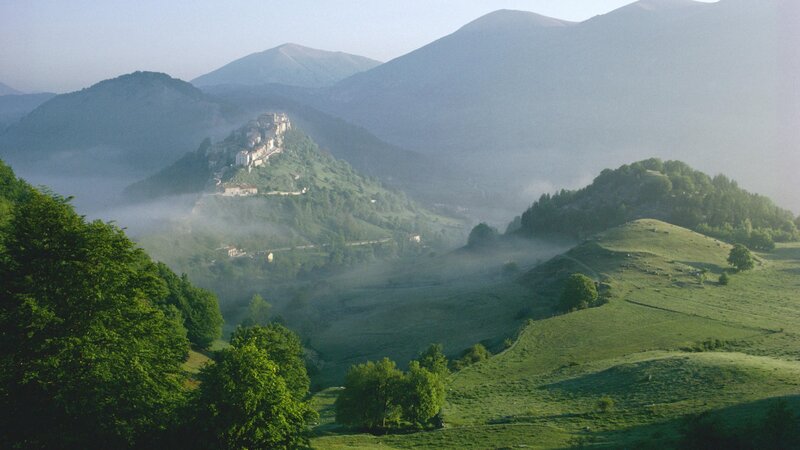 Village on a hill in mist