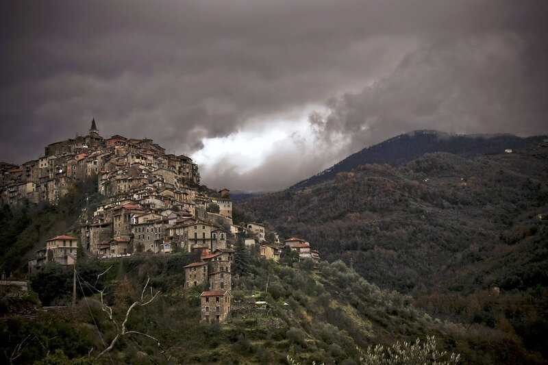 Village on a hill under stormy sky