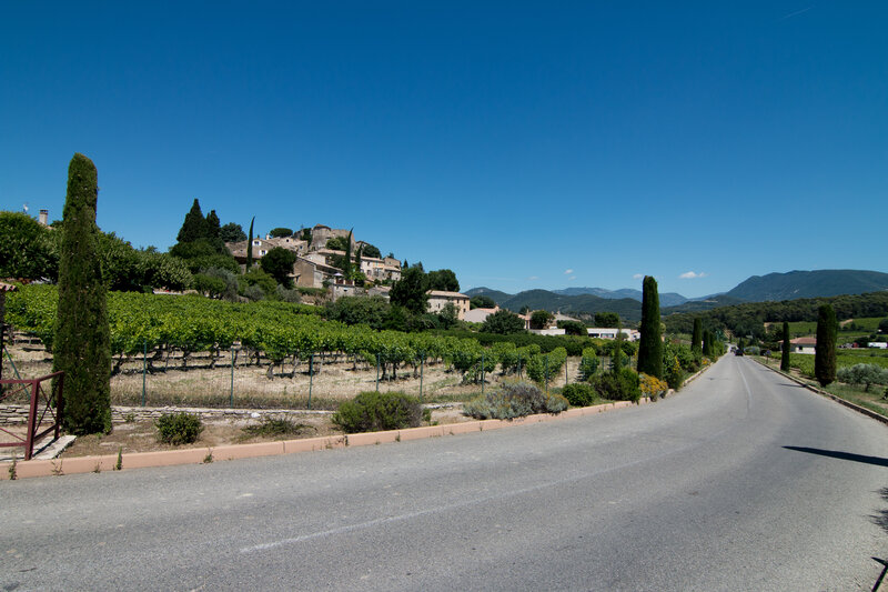Village on a Hillside — Blue, Serene, Afternoon, Photograph, Road