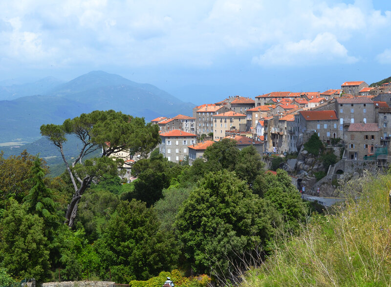Village on a Hillside — Green, Serene, Afternoon, Photograph, Mountains, Trees