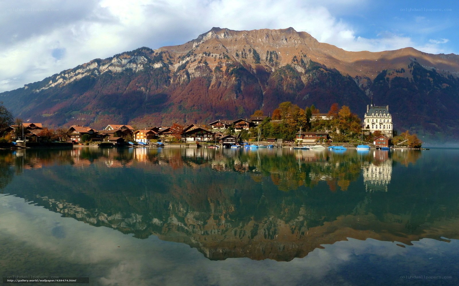 Village on a lake with mountain reflection