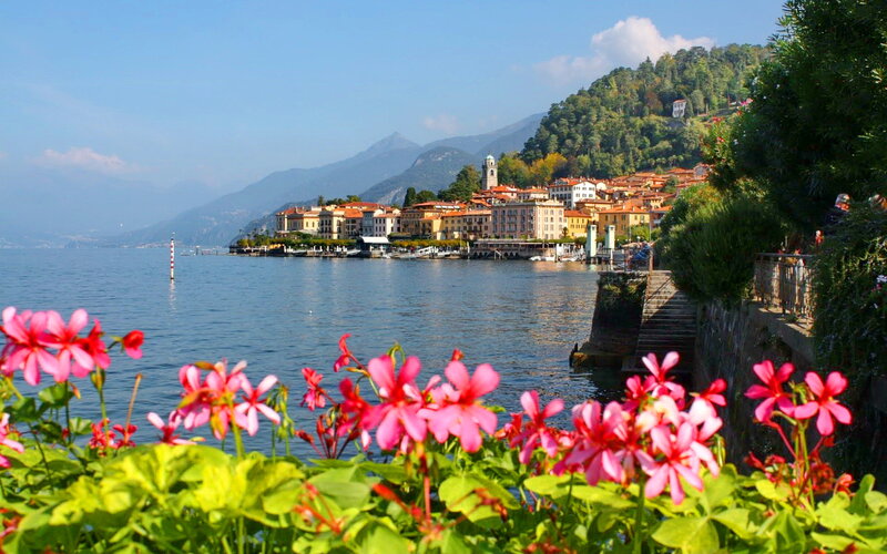 Village on Lake Shore — Blue, Serene, Afternoon, Photograph, Flowers, Mountains
