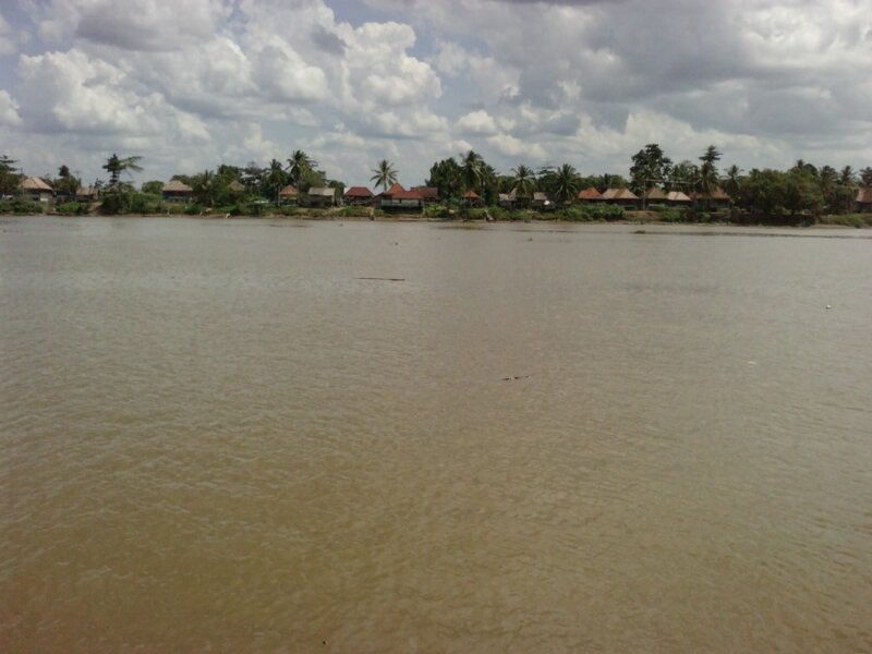 Village on Riverbank — Brown