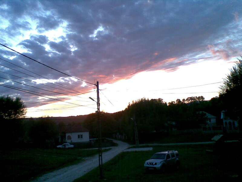 village sunset with cars
