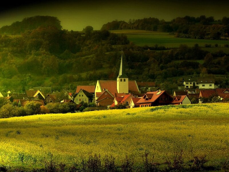 village with church in green hills