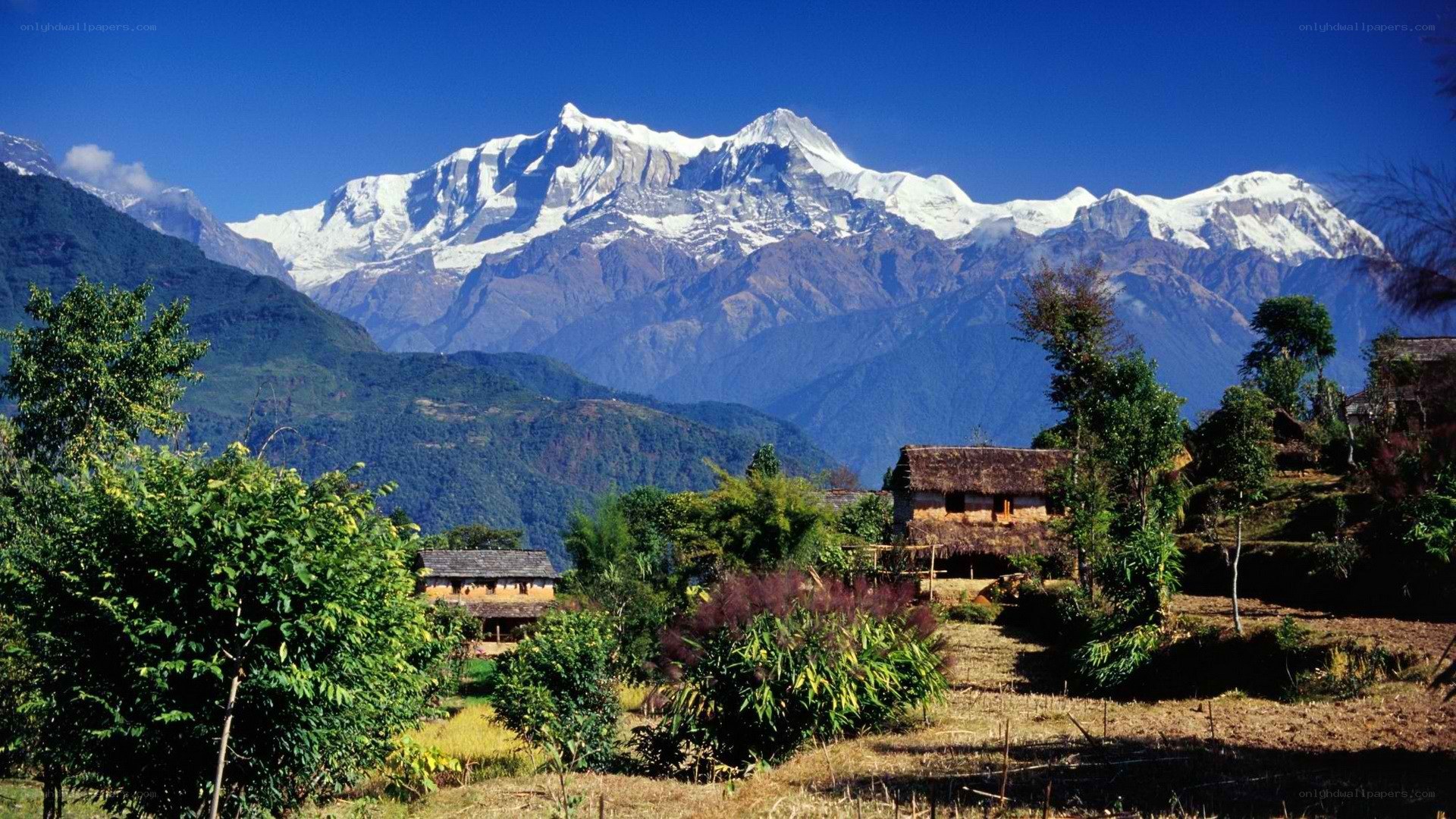 Village with snow-capped mountains