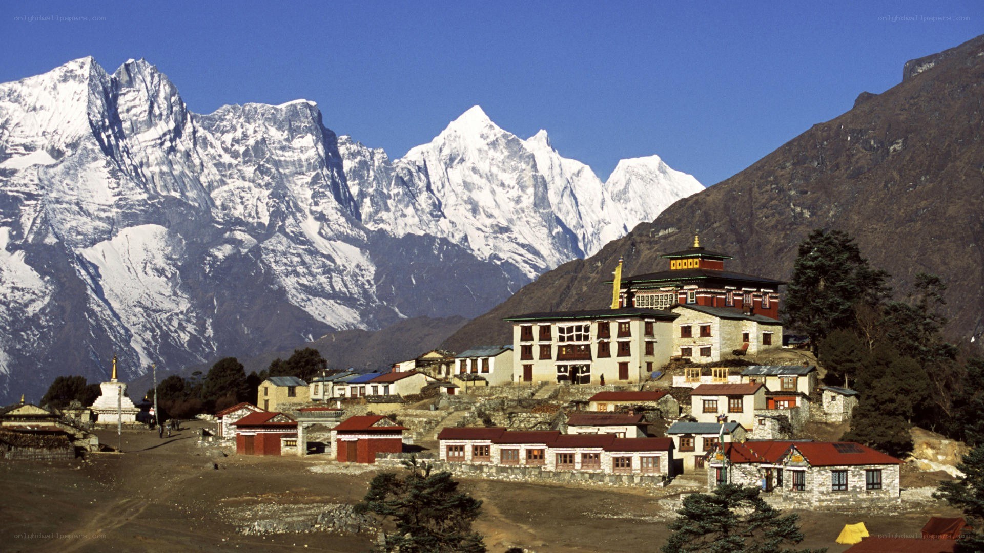 village with snow-capped mountains