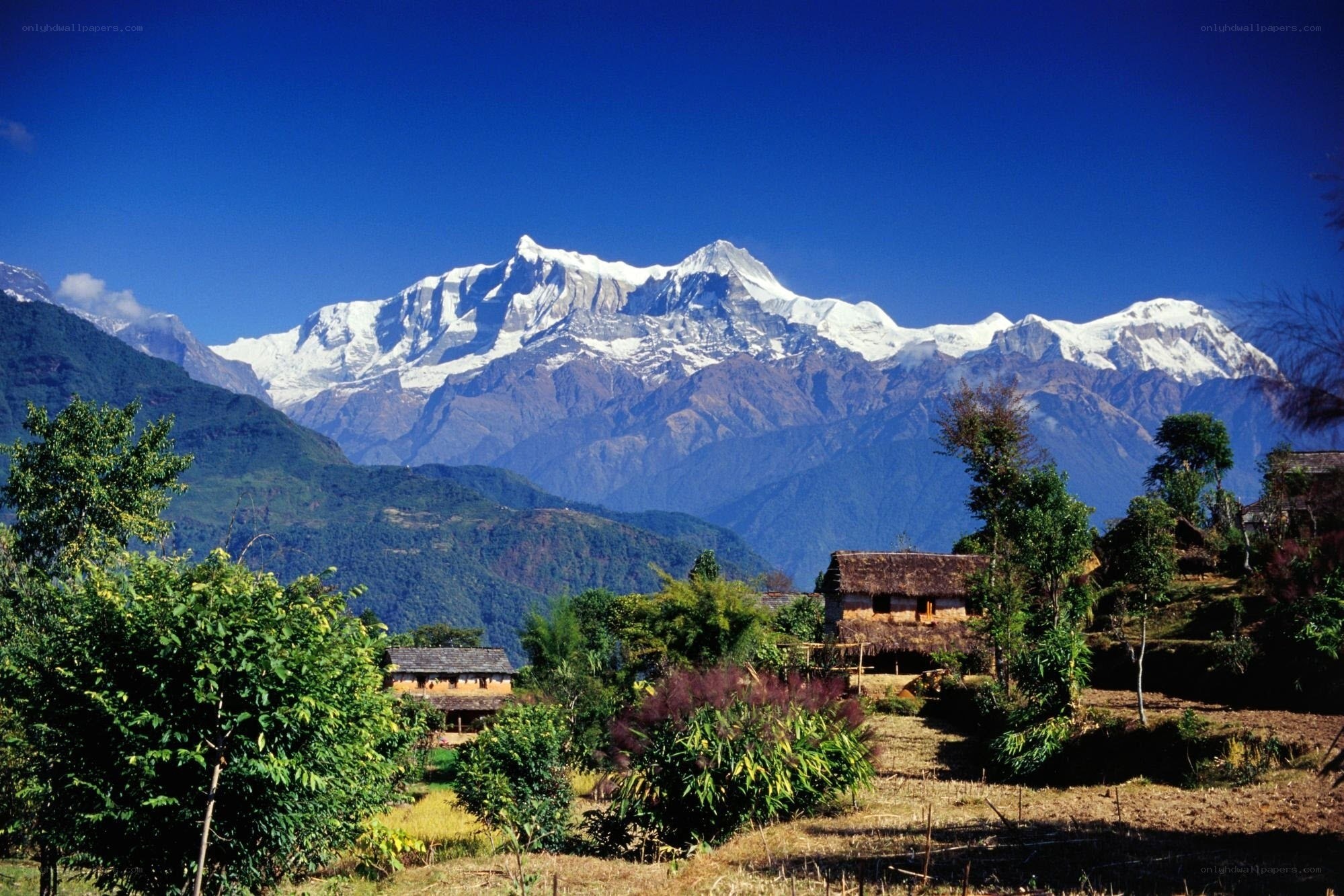 Village with snow-capped mountains