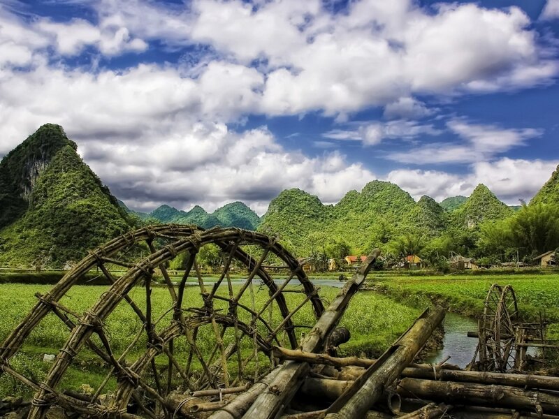 Village with water wheels and karst mountains