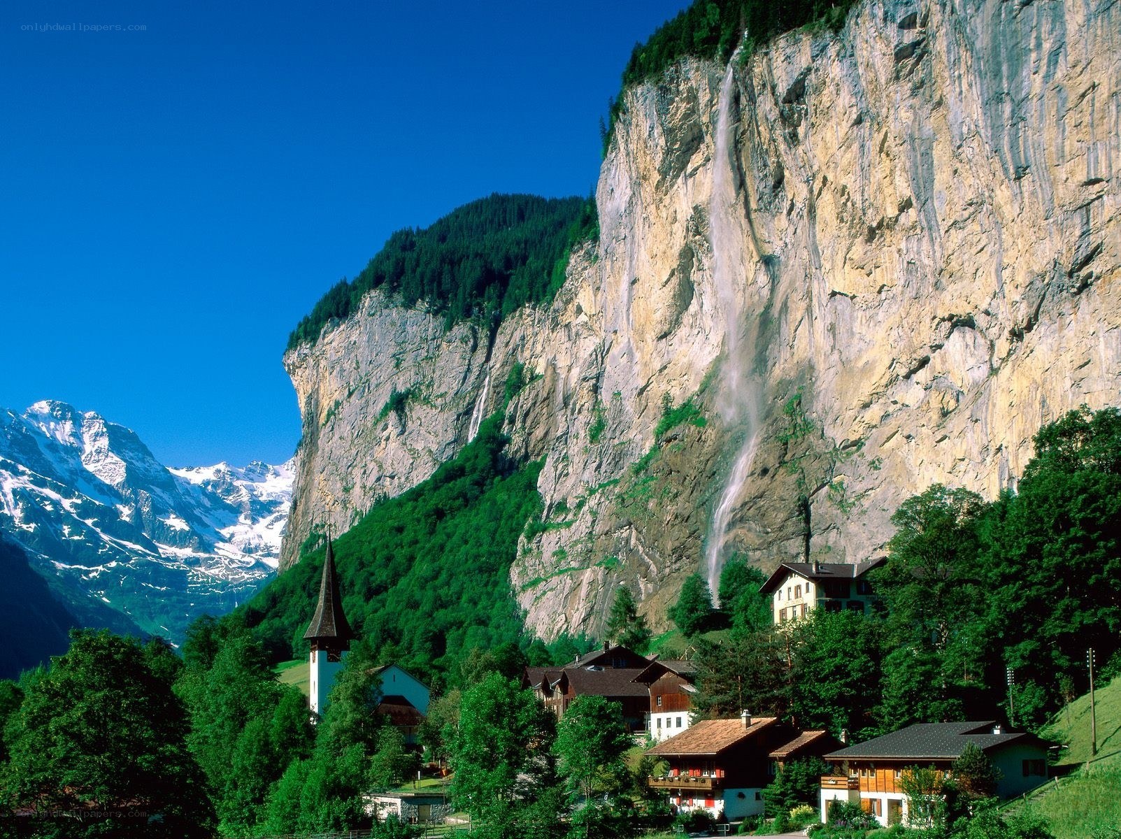 village with waterfall and mountains