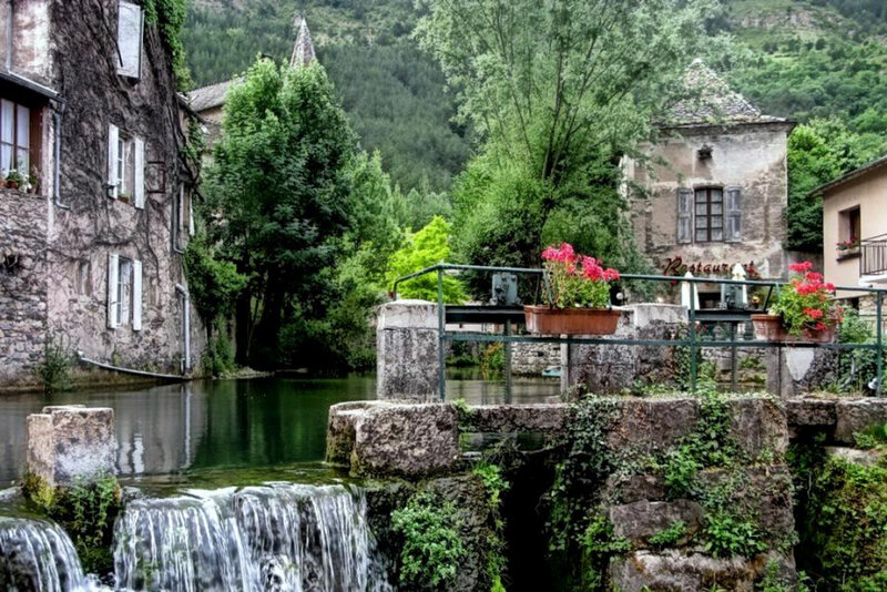 Village with waterfall and old buildings