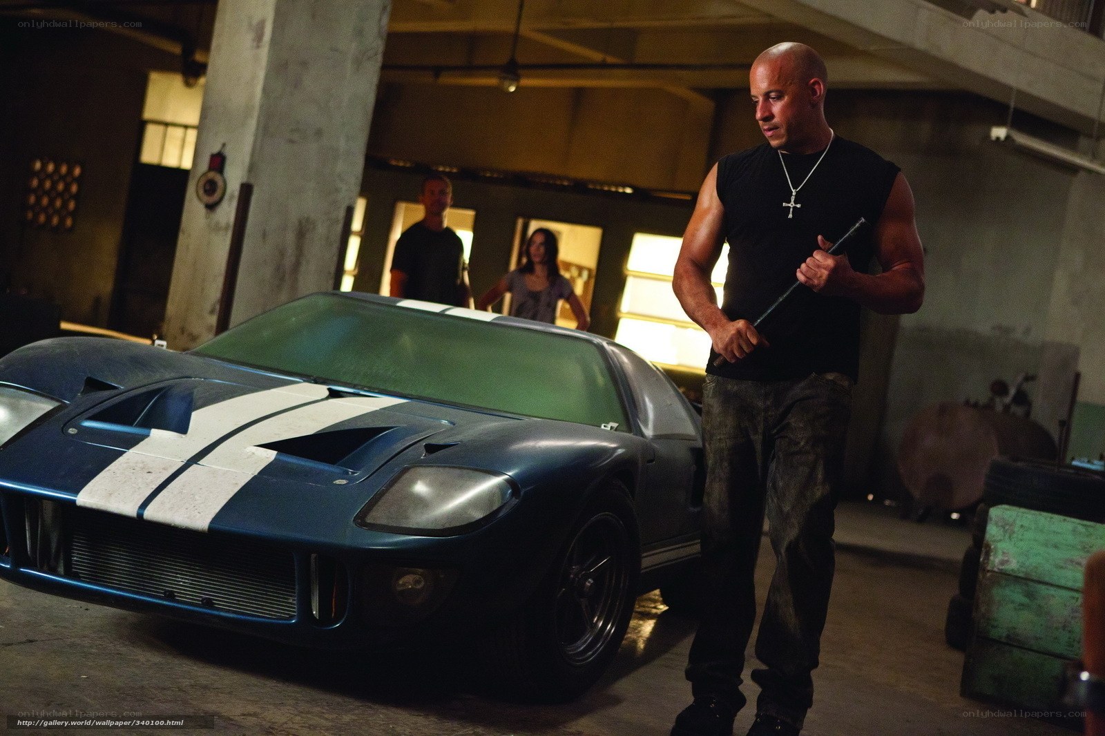 Vin Diesel with a car in a garage