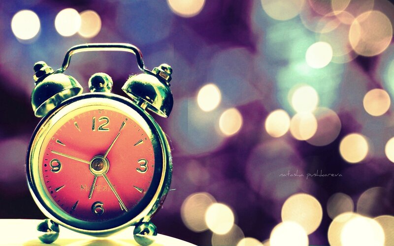 Vintage alarm clock with bokeh lights