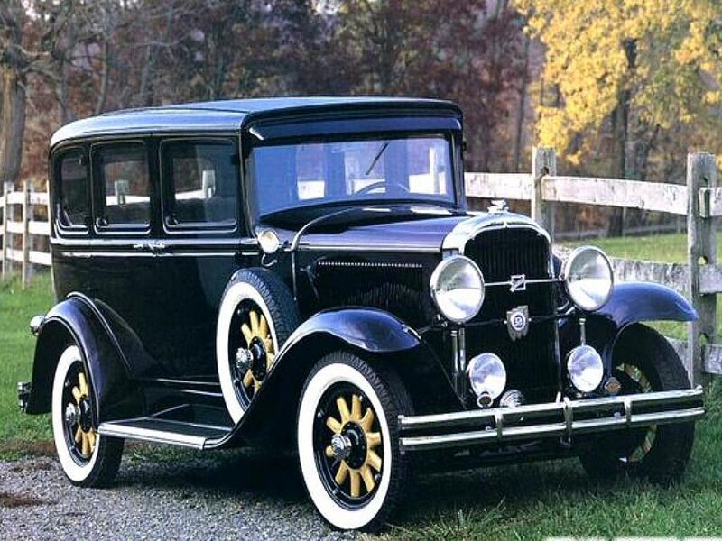 vintage black car on gravel