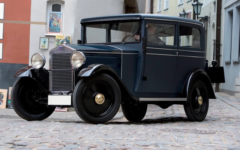 vintage blue car on cobblestone street