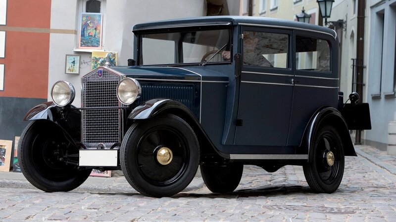 vintage blue car on cobblestone street