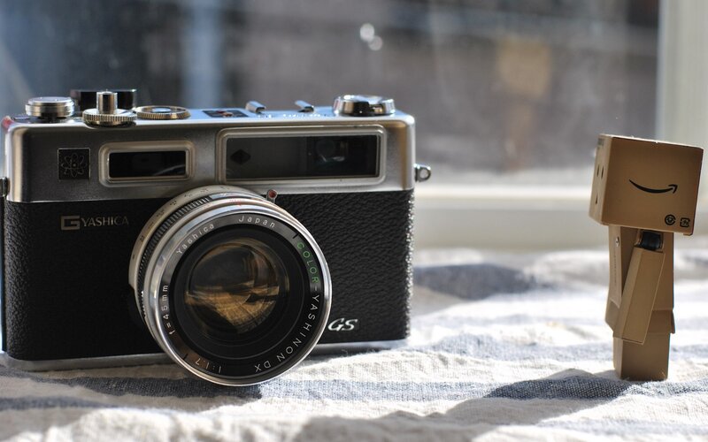 Vintage Camera and Cardboard Figure — Black