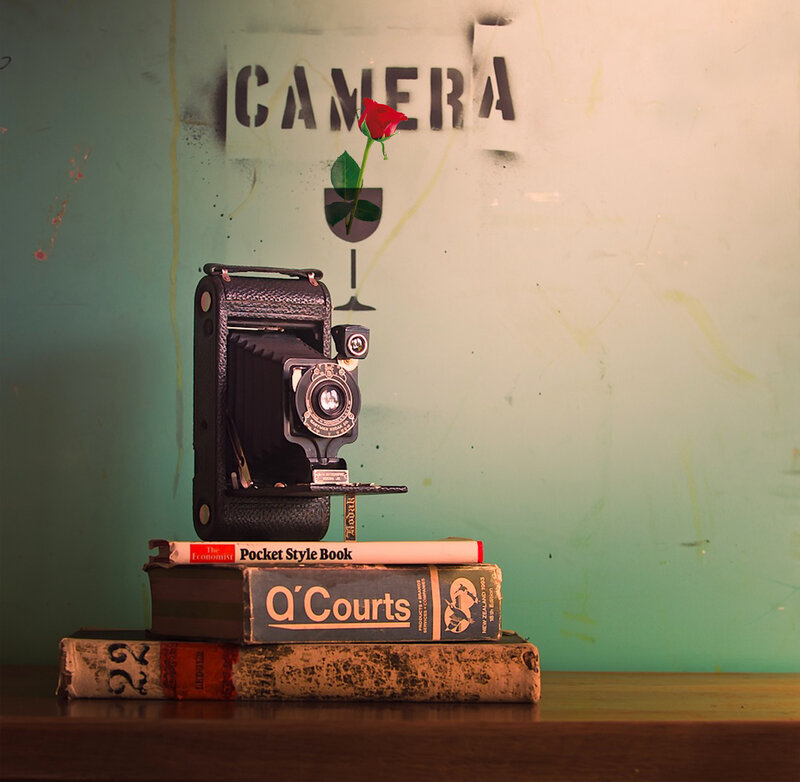 Vintage Camera on Books — Green