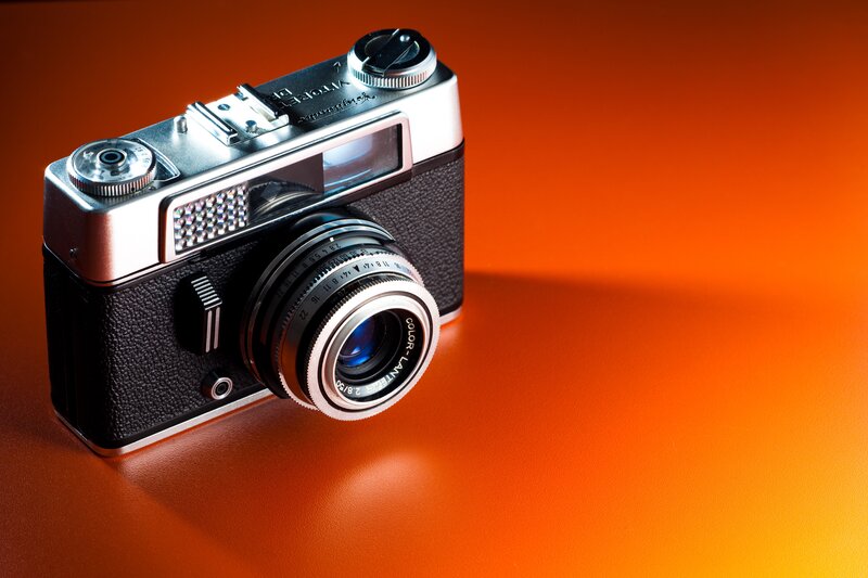 vintage camera on orange background