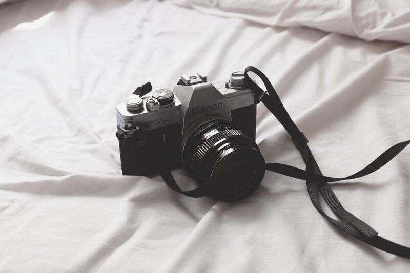 vintage canon camera on bed