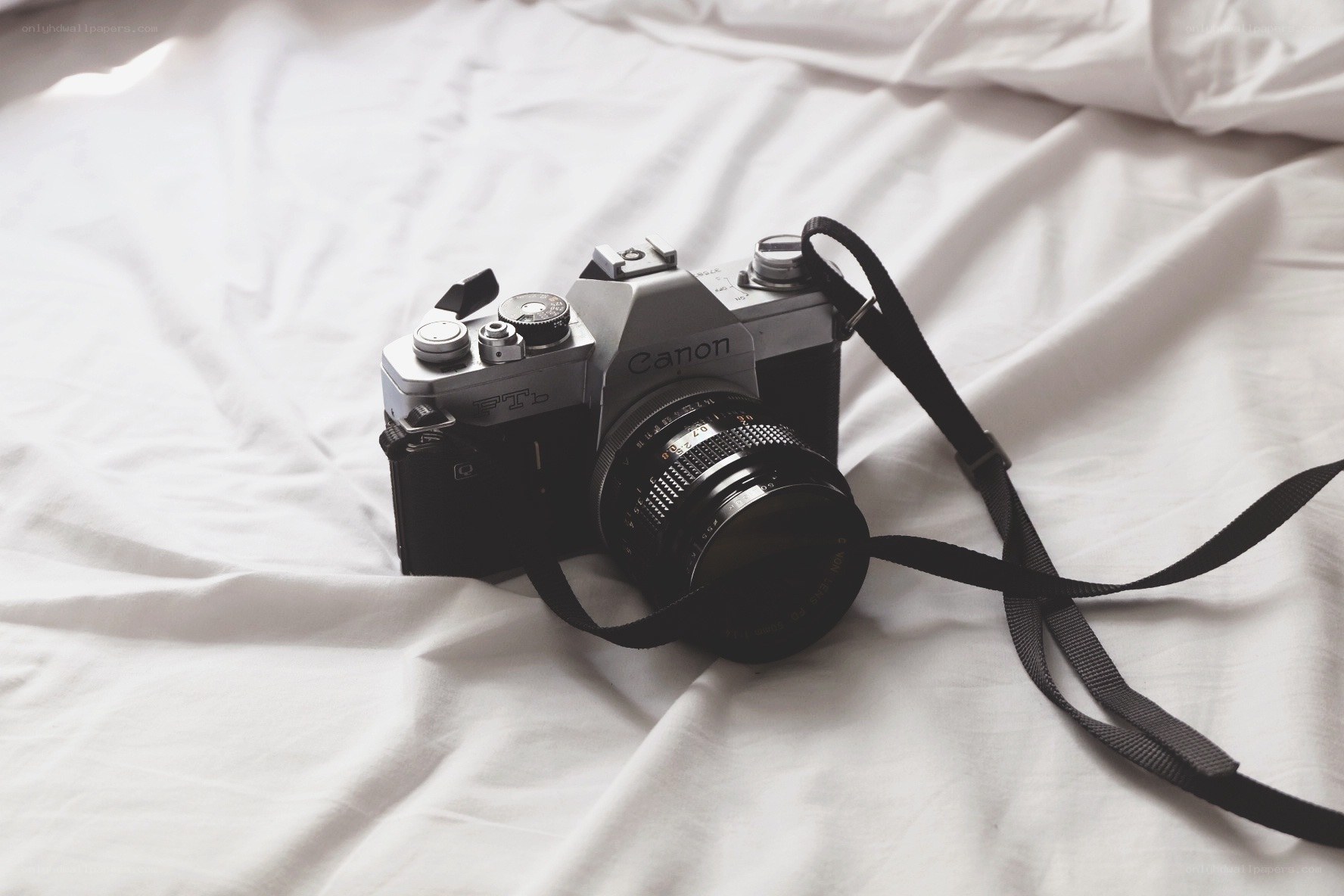 vintage canon camera on bed