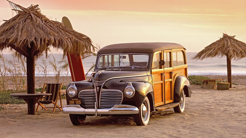 Vintage car on beach at sunset
