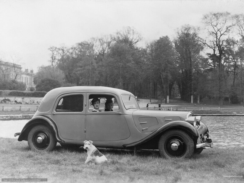 Vintage car with passengers and dog