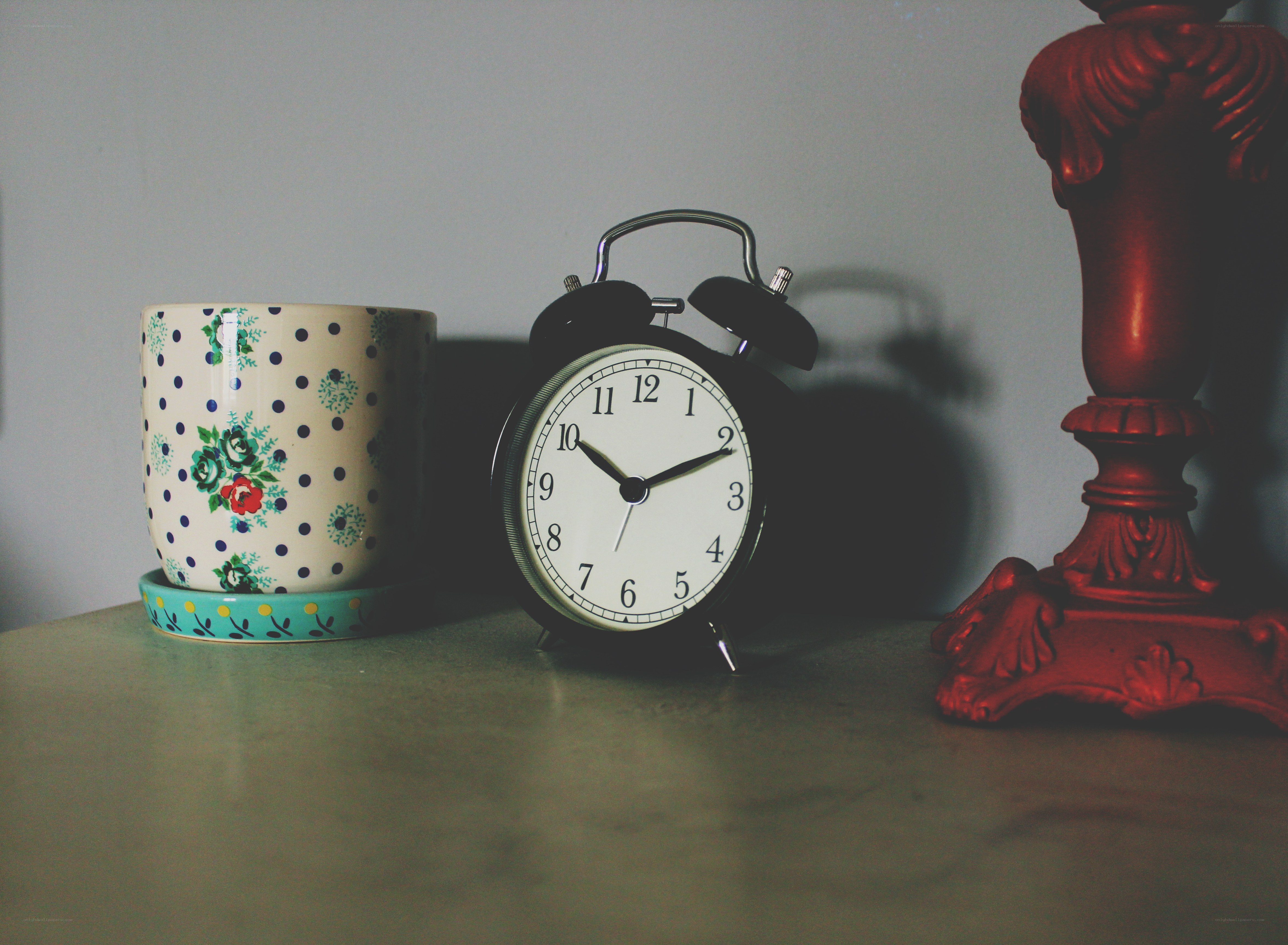 vintage clock and mug on table