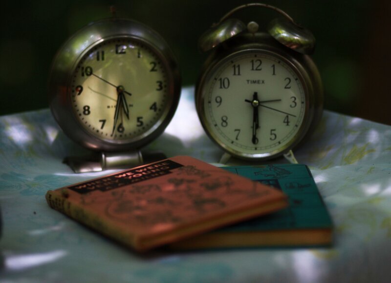 Vintage clocks and books on a table