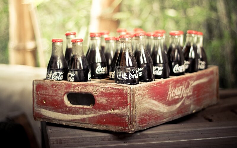 vintage coca-cola bottles in crate