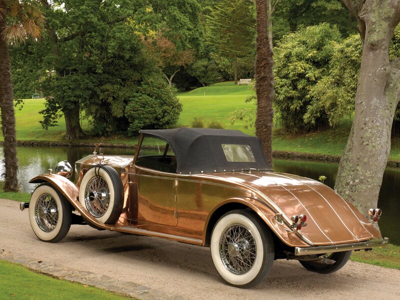 Vintage copper car by a pond
