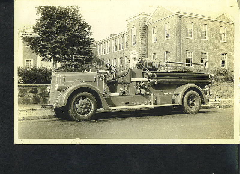 vintage fire truck parked outside building