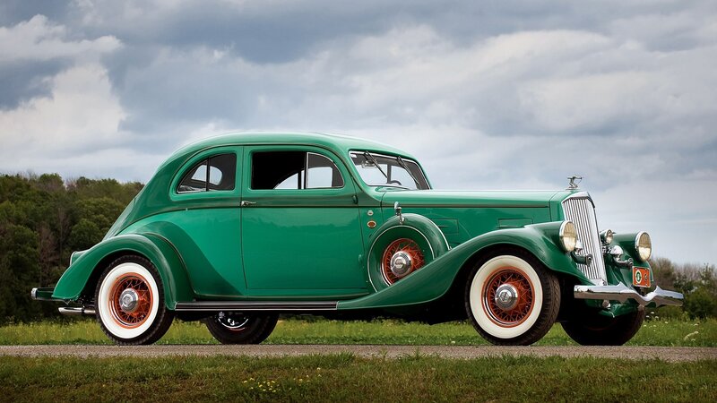 vintage green car on grass