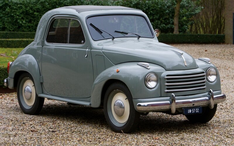 vintage green car on gravel
